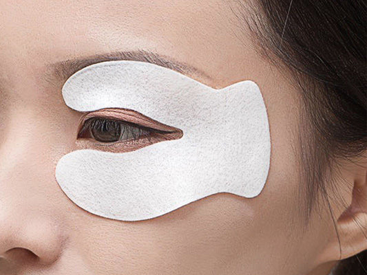 A woman's right eye has an eye patch on her upper and lower skin.